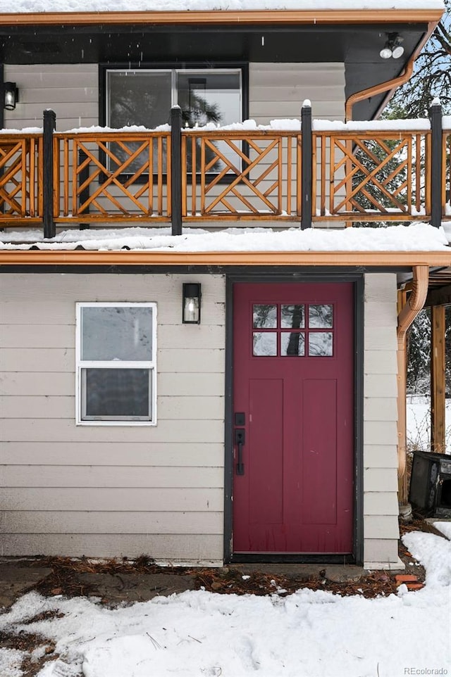 11710 Spruce Canyon Cir, Golden, CO 80403 - snow covered property entrance with a balcony
