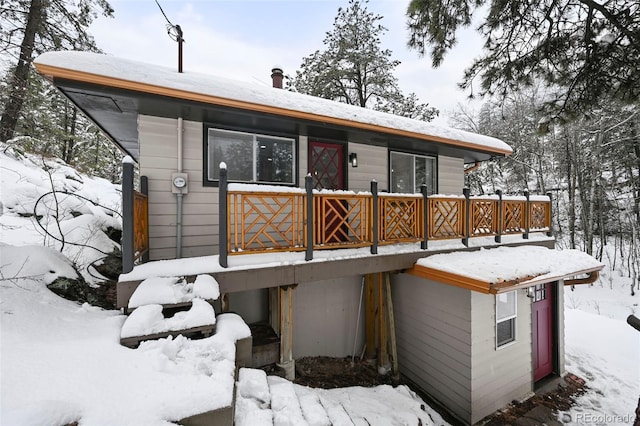 11710 Spruce Canyon Cir, Golden, CO 80403 - snow covered back of property featuring a deck