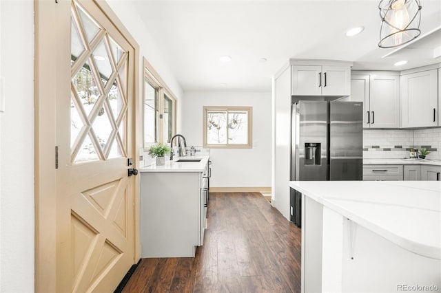 11710 Spruce Canyon Cir, Golden, CO 80403 - kitchen with stainless steel fridge, plenty of natural light, backsplash, a sink, and recessed lighting