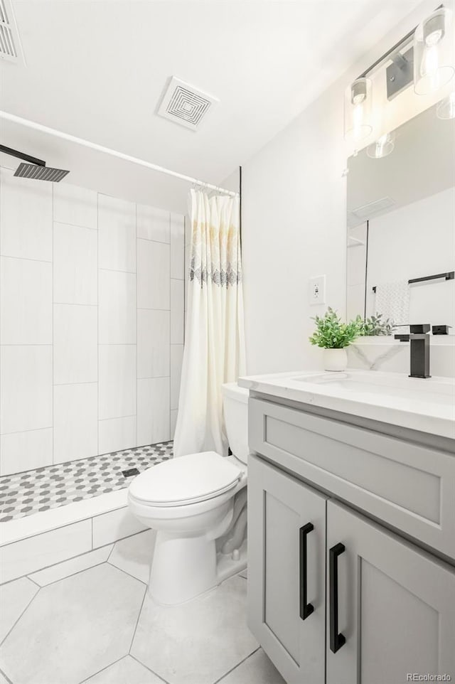 11710 Spruce Canyon Cir, Golden, CO 80403 - full bathroom with toilet, a tile shower, vanity, and tile patterned flooring