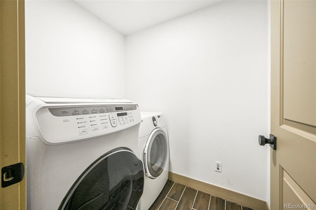 11710 Spruce Canyon Cir, Golden, CO 80403 - laundry room featuring separate washer and dryer, dark wood-style floors, and baseboards