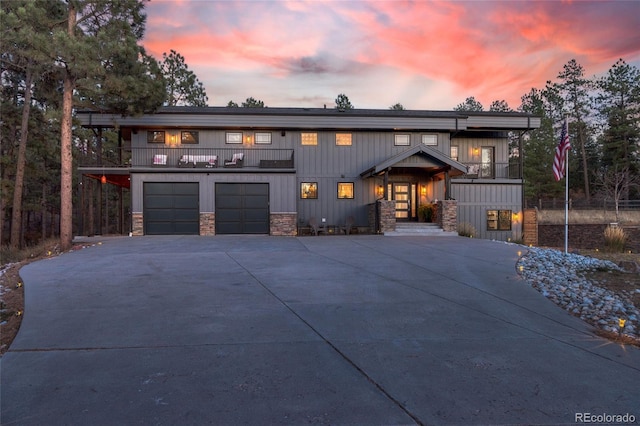 view of front of property with a garage and a balcony