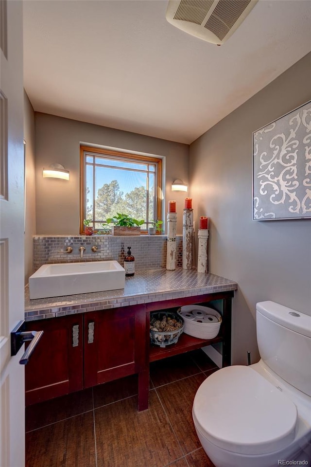 bathroom featuring vanity, tile patterned floors, and toilet