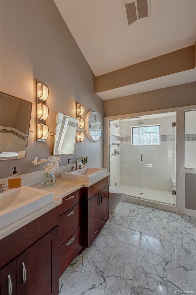 bathroom featuring an enclosed shower, vanity, and toilet