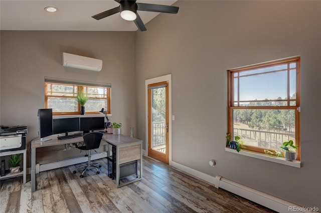 office space featuring a baseboard radiator, wood-type flooring, a wall mounted AC, and high vaulted ceiling