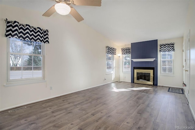 unfurnished living room with visible vents, a ceiling fan, wood finished floors, a fireplace, and lofted ceiling