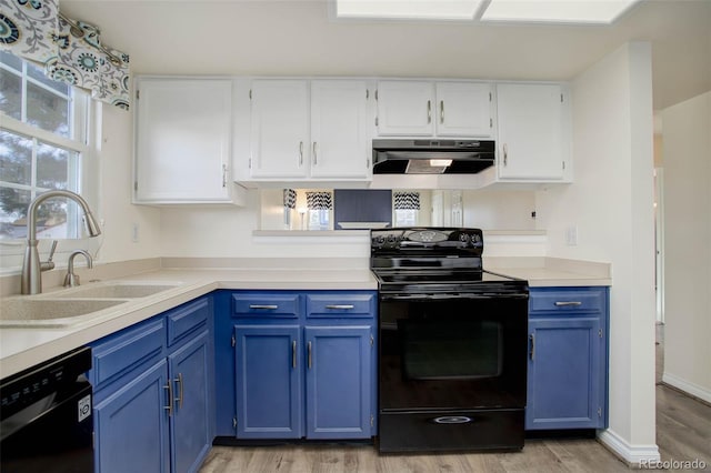 kitchen with blue cabinetry, black appliances, under cabinet range hood, white cabinetry, and a sink