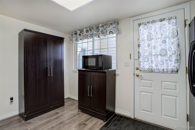 entrance foyer featuring baseboards and light wood finished floors