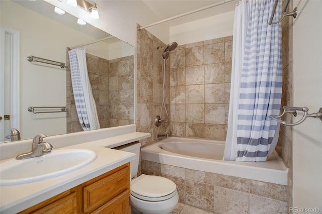 full bathroom featuring toilet, vanity, and tiled shower / bath