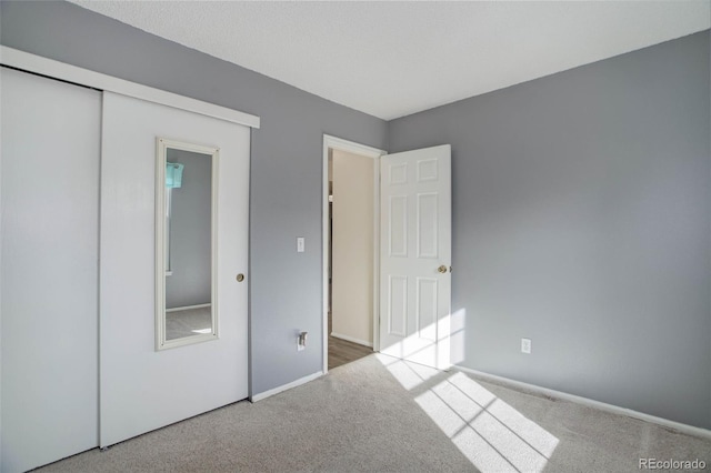 unfurnished bedroom featuring a closet and carpet