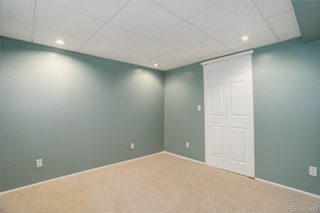 unfurnished room with recessed lighting, a paneled ceiling, baseboards, and carpet floors