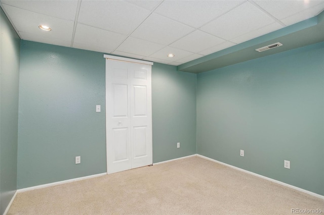 carpeted empty room featuring recessed lighting, baseboards, visible vents, and a paneled ceiling