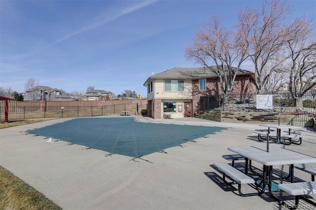 view of swimming pool with a patio area, a fenced in pool, and a fenced backyard