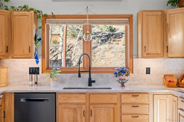 kitchen with a sink, tasteful backsplash, light countertops, and dishwasher