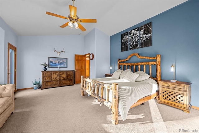 bedroom with carpet floors, vaulted ceiling, ceiling fan, and baseboards