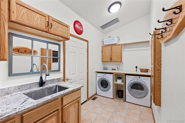 clothes washing area with light tile patterned floors, a sink, visible vents, cabinet space, and washer and clothes dryer