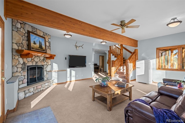 carpeted living area featuring baseboards, tile patterned flooring, stairs, a stone fireplace, and beam ceiling