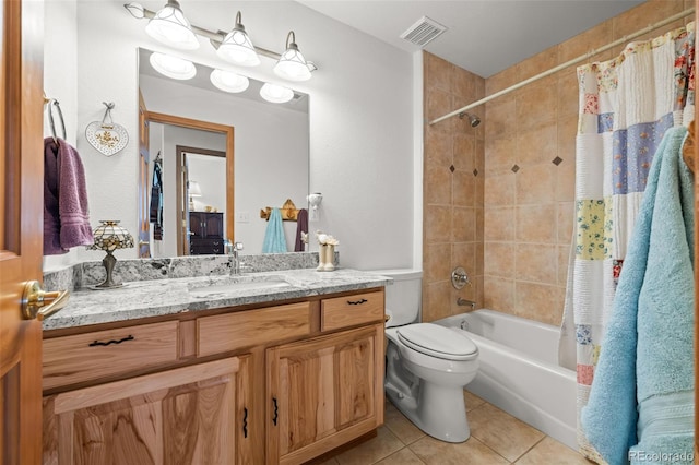 bathroom featuring visible vents, toilet, shower / tub combo, vanity, and tile patterned floors