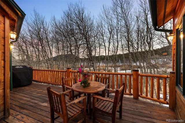 wooden deck featuring a grill