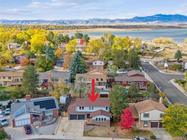 birds eye view of property featuring a water and mountain view