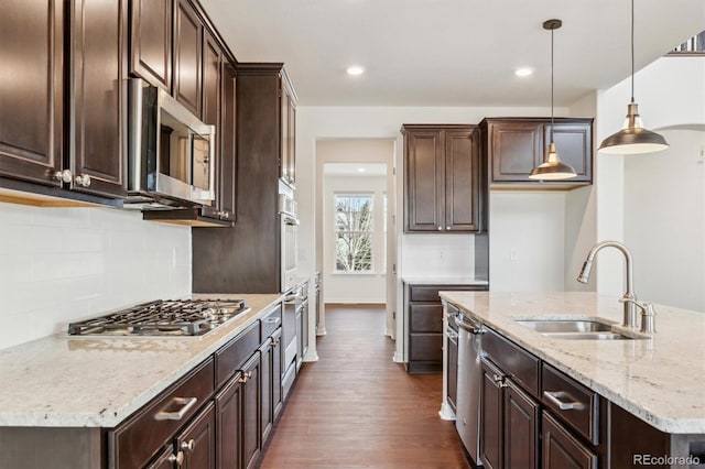 kitchen featuring dark brown cabinetry, appliances with stainless steel finishes, and a sink