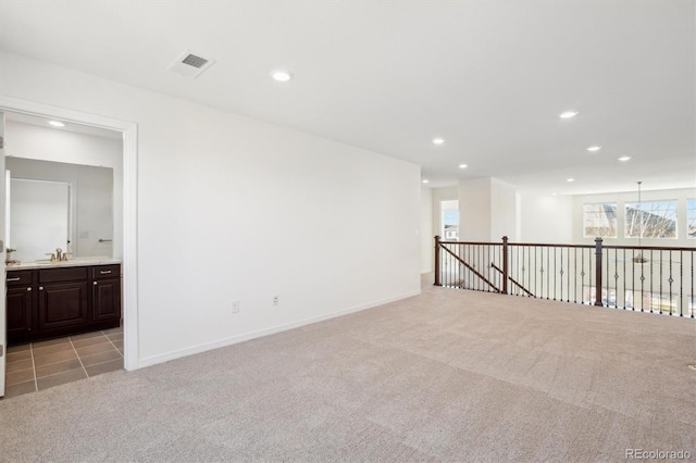 spare room featuring recessed lighting, visible vents, light carpet, and baseboards