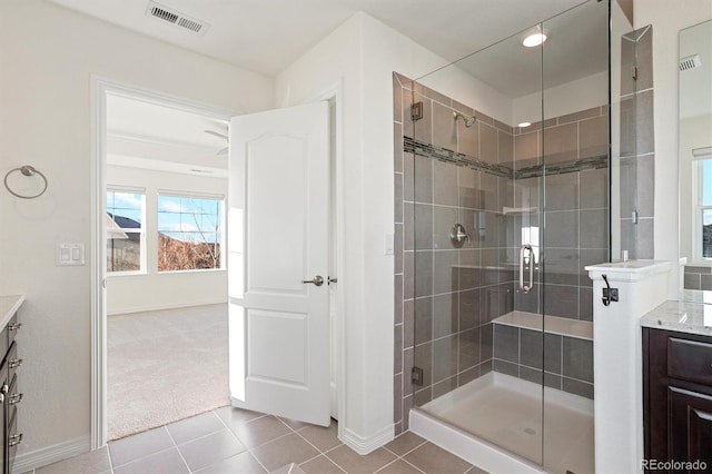 bathroom featuring vanity, baseboards, visible vents, a stall shower, and tile patterned flooring