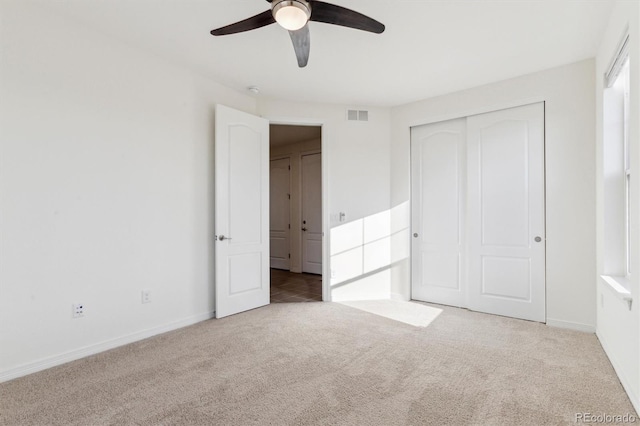 unfurnished bedroom with visible vents, ceiling fan, baseboards, carpet, and a closet