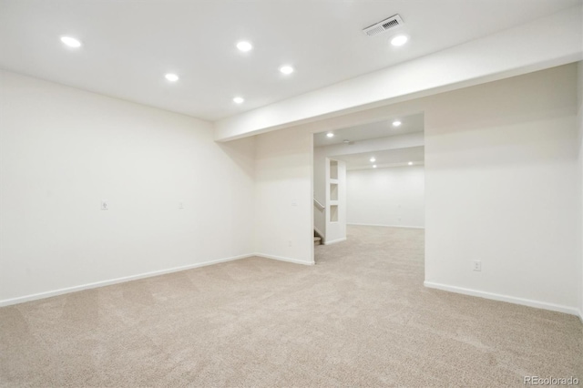 finished below grade area with recessed lighting, visible vents, and light colored carpet