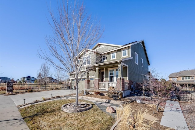 craftsman-style house with a garage, fence, covered porch, and driveway