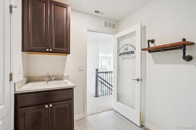 bathroom featuring vanity, tile patterned floors, baseboards, and visible vents