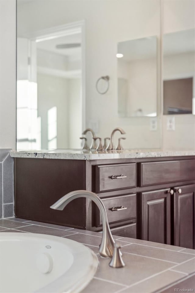 bathroom with a bathing tub and vanity