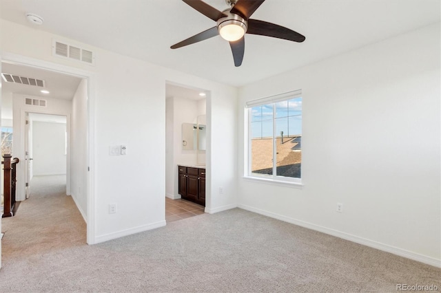 unfurnished bedroom with light colored carpet, visible vents, and baseboards