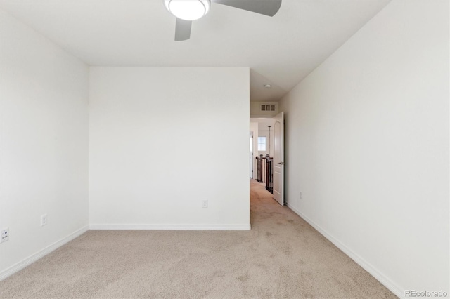 unfurnished room featuring light carpet, visible vents, and baseboards