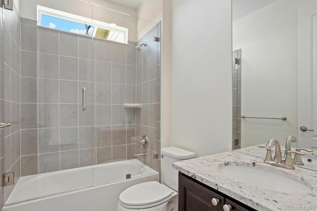 full bathroom with shower / bath combination with glass door, toilet, and vanity