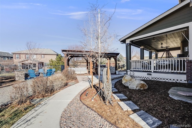 view of yard with a gazebo, a ceiling fan, and fence