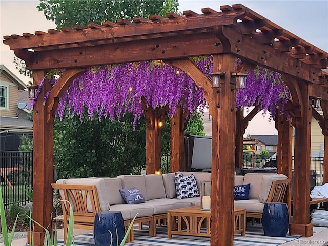 view of patio / terrace featuring an outdoor living space, fence, and a pergola