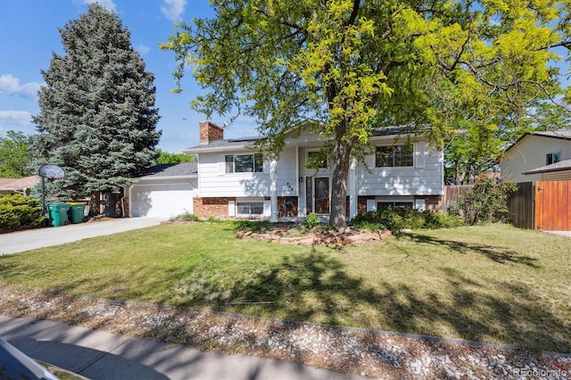 848 S 13th Ave, Brighton, CO 80601 - bi-level home featuring roof mounted solar panels, a chimney, brick siding, and driveway