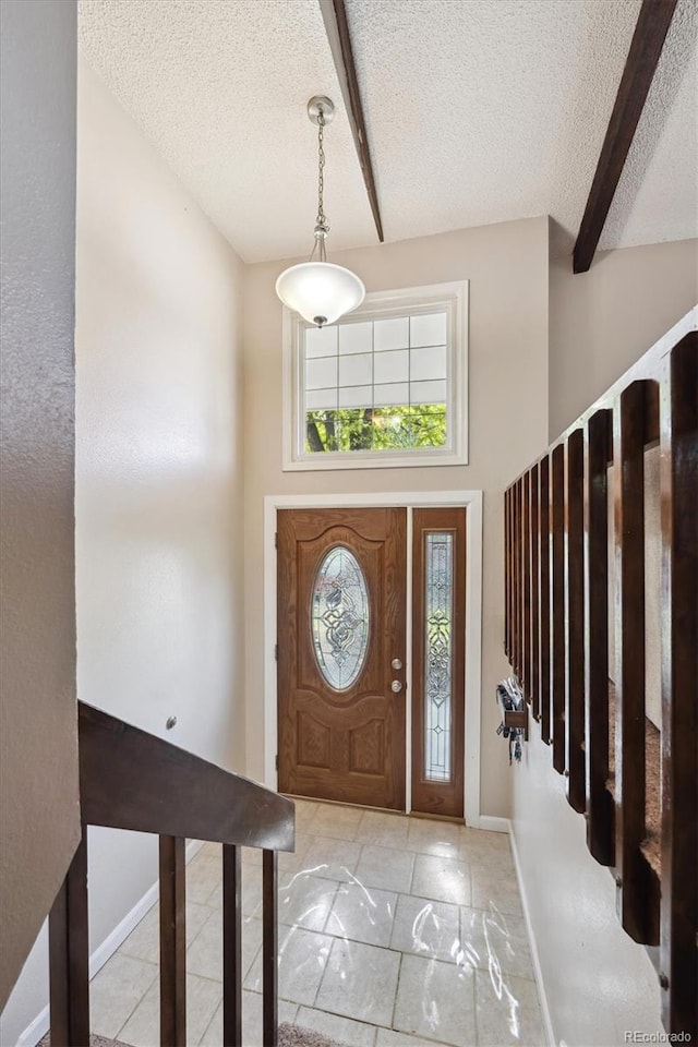 848 S 13th Ave, Brighton, CO 80601 - foyer entrance with a textured ceiling, baseboards, and a towering ceiling