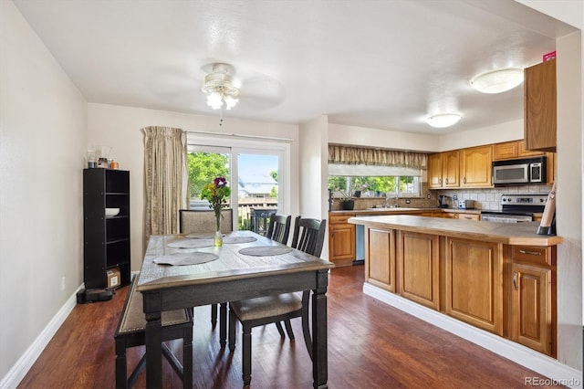 848 S 13th Ave, Brighton, CO 80601 - dining area featuring dark wood-type flooring, ceiling fan, and baseboards