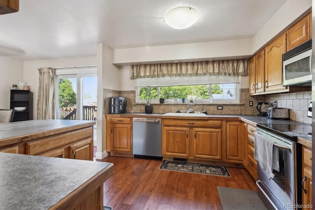 848 S 13th Ave, Brighton, CO 80601 - kitchen with appliances with stainless steel finishes, a sink, healthy amount of natural light, and dark wood-style floors