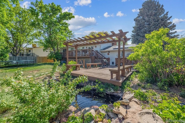 848 S 13th Ave, Brighton, CO 80601 - rear view of property featuring a trampoline, a wooden deck, and a pergola