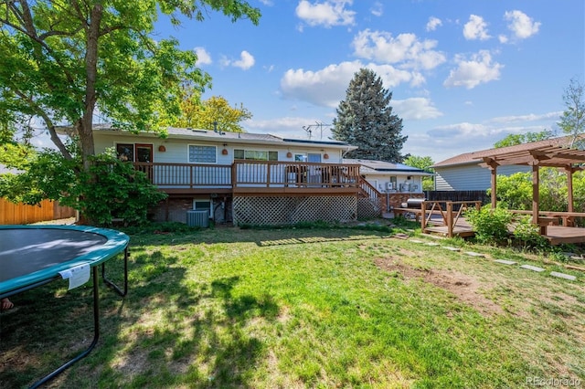 848 S 13th Ave, Brighton, CO 80601 - back of property featuring a trampoline, a deck, a yard, a pergola, and central air condition unit
