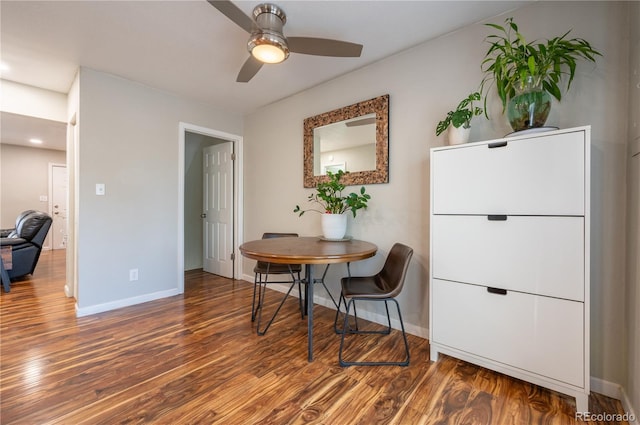 dining space with ceiling fan, baseboards, and wood finished floors