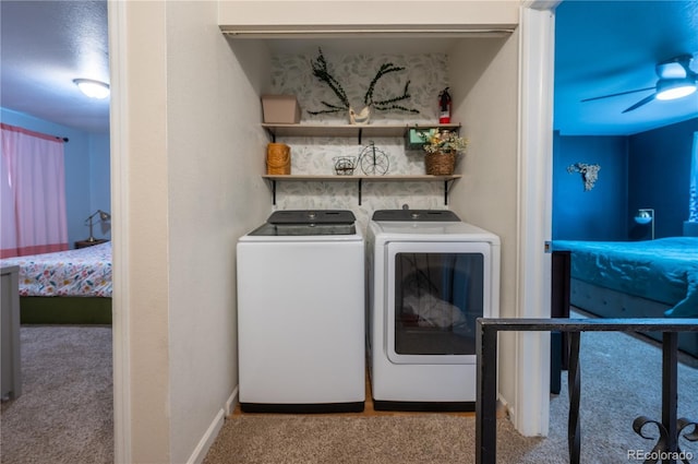 clothes washing area featuring carpet floors, laundry area, independent washer and dryer, and baseboards