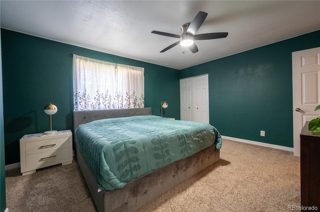 bedroom featuring a closet, carpet flooring, ceiling fan, and baseboards