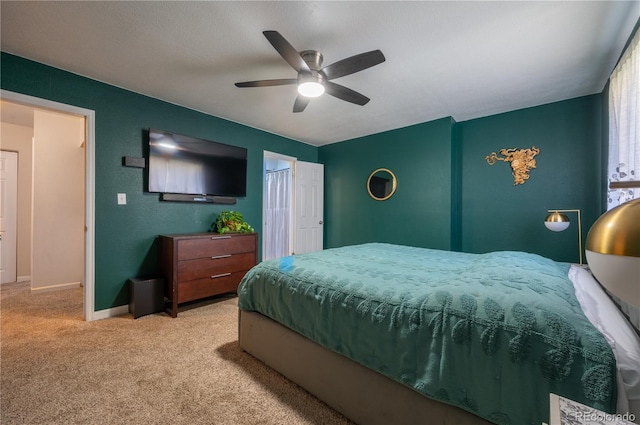 bedroom with ceiling fan, carpet floors, and baseboards