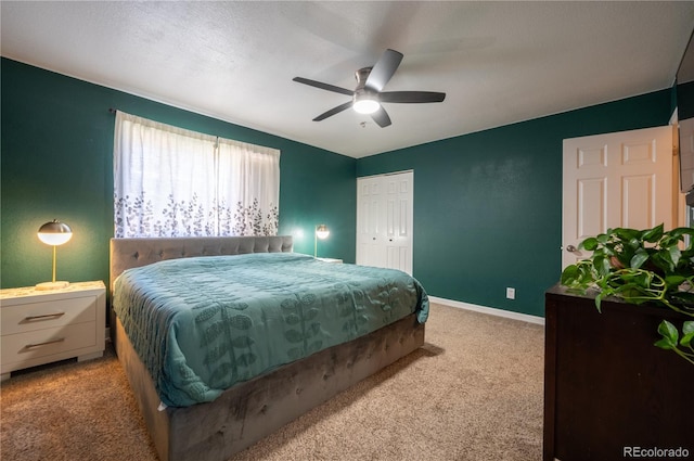 carpeted bedroom with a ceiling fan, baseboards, and a closet