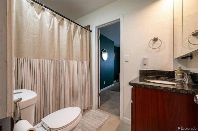 bathroom featuring vanity, toilet, and tile patterned floors