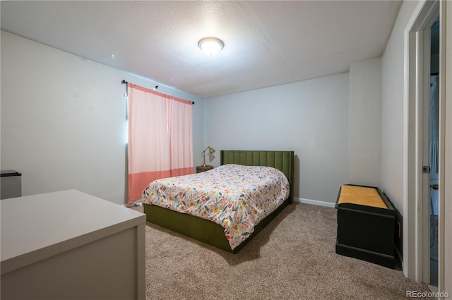 bedroom featuring a textured ceiling, carpet flooring, and baseboards